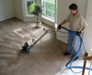 A professional technician operating a carpet cleaning machine for Alexandria Green Carpet & Rug Cleaning in Alexandria, VA.