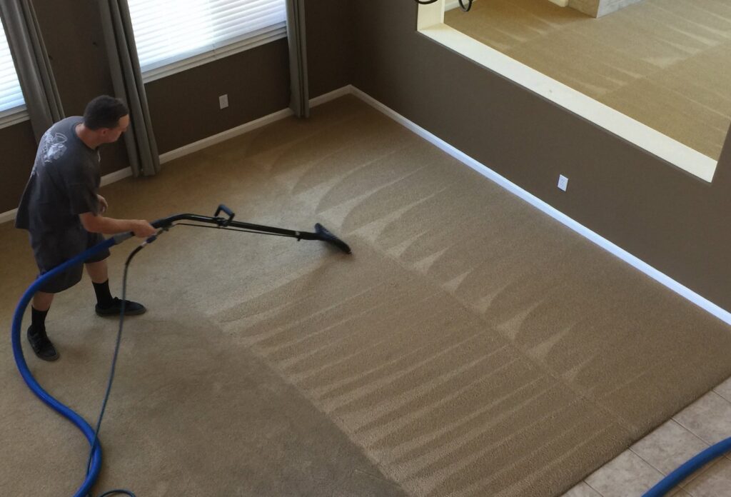 A professional performing carpet cleaning with a wand, leaving clean lines on a large carpeted area by Presto Carpet And Tile Cleaning in Brentwood, CA.