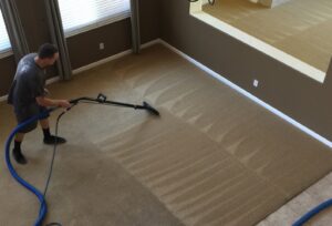 A professional performing carpet cleaning with a wand, leaving clean lines on a large carpeted area by Presto Carpet And Tile Cleaning in Brentwood, CA.
