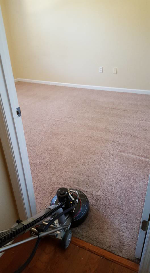 A professional carpet cleaning machine being used to clean a light brown carpet by Todd White Carpet Care LLC in Tallahassee, FL.