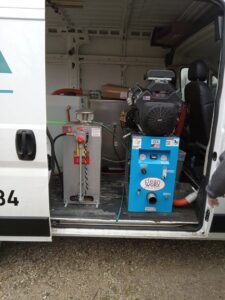 A professional carpet cleaning system and supplies inside an Alpha Clean service van in Fort Wayne, IN.