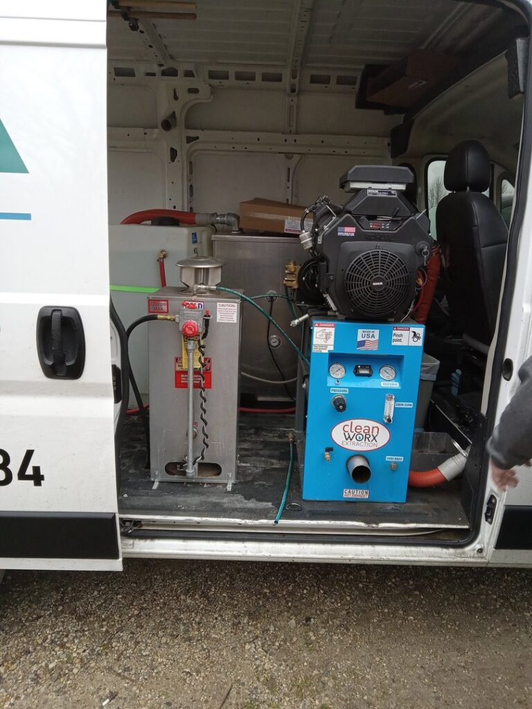 A professional carpet cleaning system and supplies inside an Alpha Clean service van in Fort Wayne, IN.