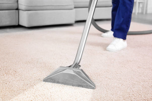 A professional using a carpet cleaning wand to clean a light-colored carpet by Atlantic Carpet Care, Inc. in Chesapeake, VA