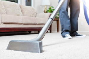 A professional carpet cleaning wand being used on a light-colored carpet by Empire Carpet Cleaning Services in Omaha, NE.