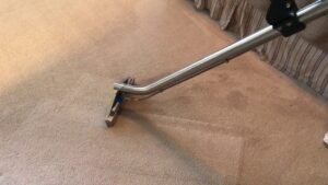 A professional carpet cleaning wand in action on a light-colored carpet by Zerorez Nashville, TN