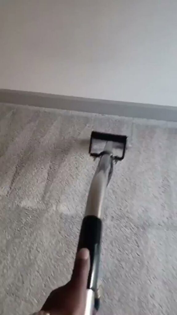 A professional carpet cleaning wand being used to clean a light-colored carpet by Superior Carpet Cleaning And Flooring in Dallas, TX