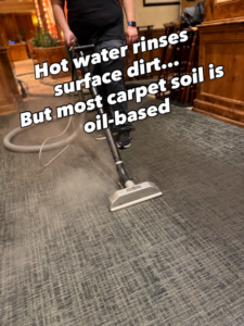 A professional carpet cleaning technician performing hot water extraction on a patterned carpet for Bullseye Carpet & Upholstery Cleaning in Boise, ID.
