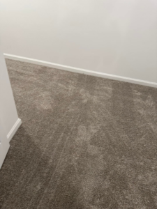 Professional grey carpet installation in a room corner by Millennium Flooring .Co in Salt Lake City, UT.