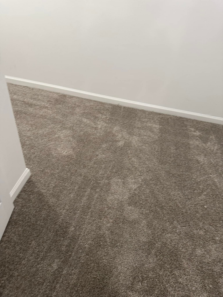 Professional grey carpet installation in a room corner by Millennium Flooring .Co in Salt Lake City, UT.