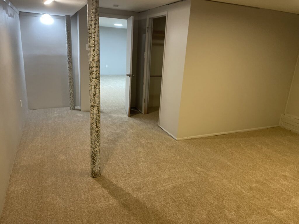 Professional carpet installation in a residential space with a support column by JJS Flooring & Decorating Co Inc in Saint Louis, MO.