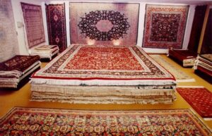 Workers performing professional oriental rug cleaning with specialized machines at Demanes Oriental Rugs in Peoria, IL