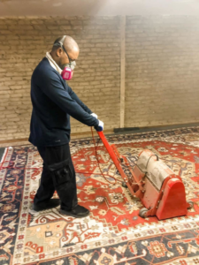 A professional using a specialized machine for rug cleaning at George Bell Rug Cleaning & Restoration in Jackson, MS.