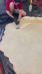A technician performing professional rug cleaning with an extraction wand at Thomas' Carpet Cleaning & Restoration Service, LLC in Clarksville, TN.