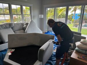 A professional performing upholstery cleaning for Arise Carpet Cleaning in Kailua, HI.