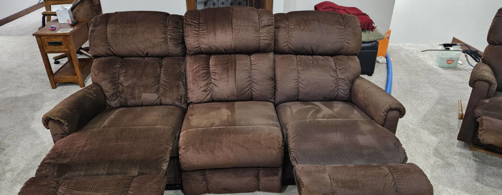 Professional upholstery cleaning on a brown sofa by American Carpet Care, Inc. in Watertown, SD.