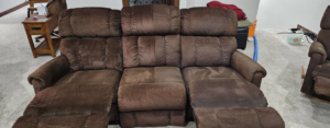 Professional upholstery cleaning on a brown sofa by American Carpet Care, Inc. in Watertown, SD.