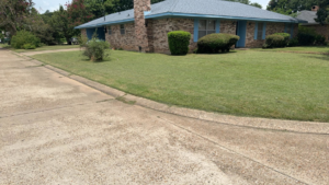 A professionally edged lawn in front of a brick home by Minors lawn care service in Canton, OH.