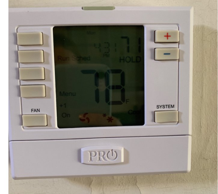 A programmable thermostat installed on a wall by Metro Air Conditioning, Heating & Services in Dallas, TX