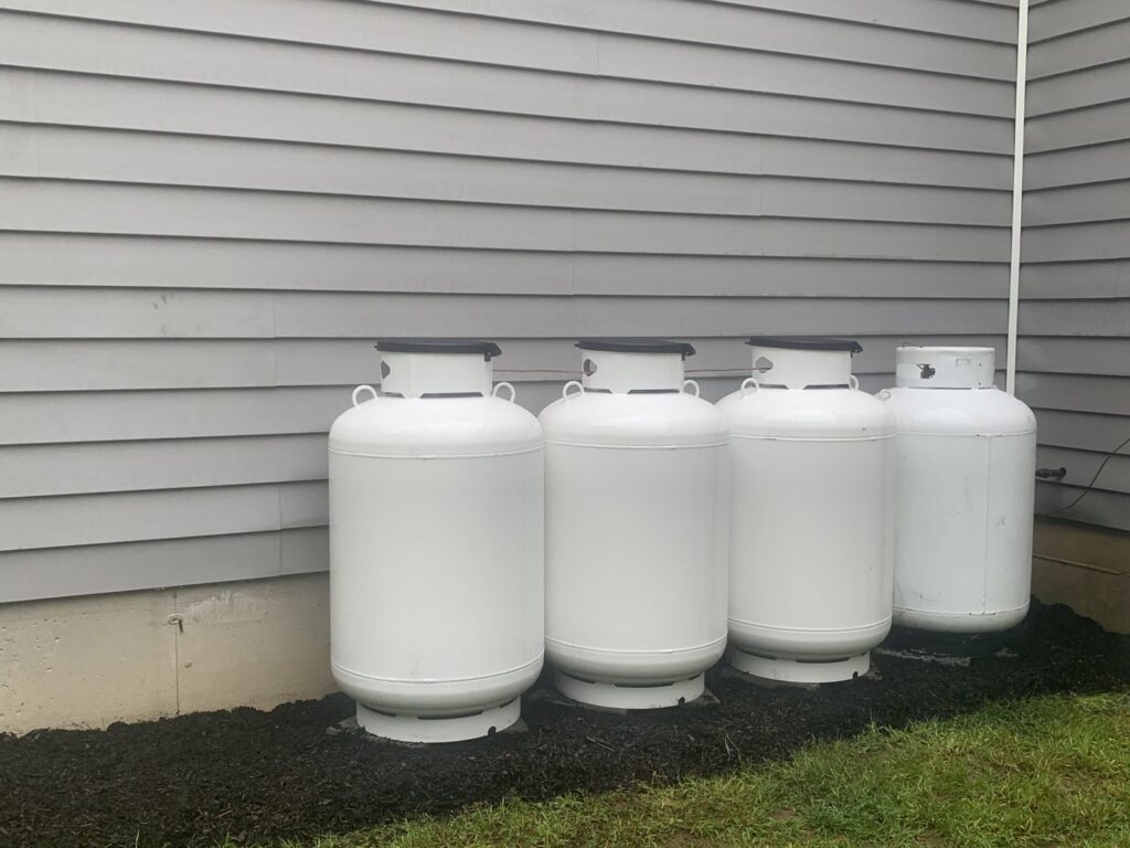 Propane tanks providing fuel for a heating system, serviced by Call The Bee Plumbing, Heating, Air & Electric in Farmington, CT.
