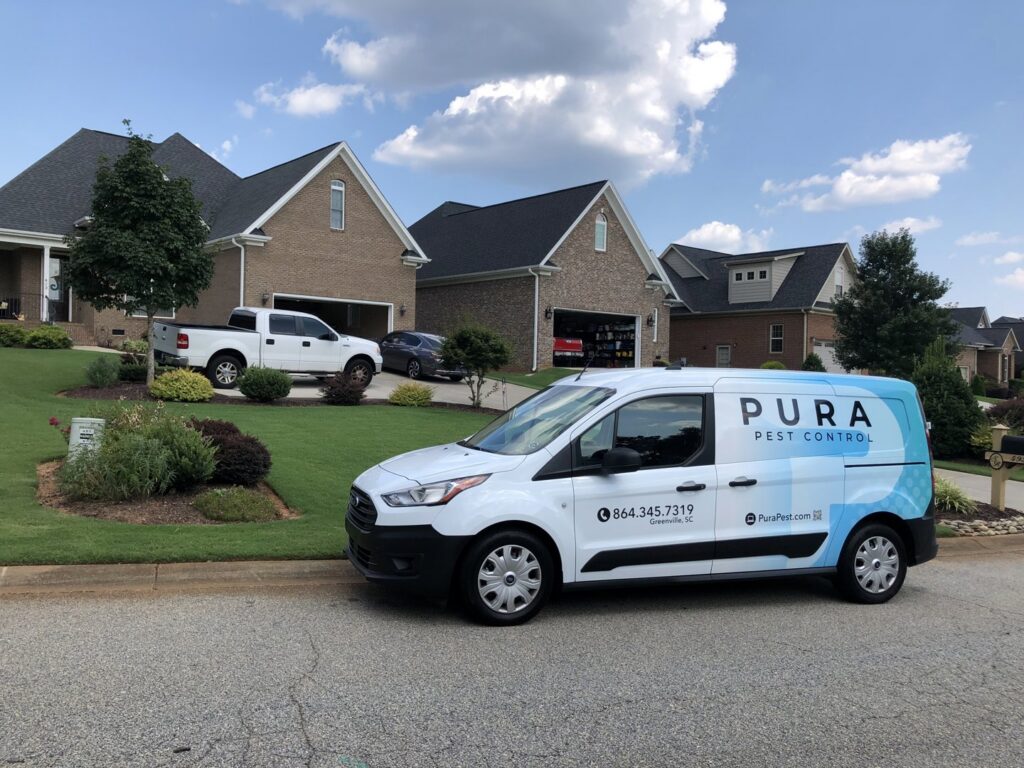 Pura Pest Control van parked at a client's home, ready for service in Greenville, SC