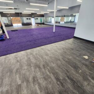 Installation of vibrant purple commercial carpet in a large open space by LaValle Flooring Inc - Jamestown, ND