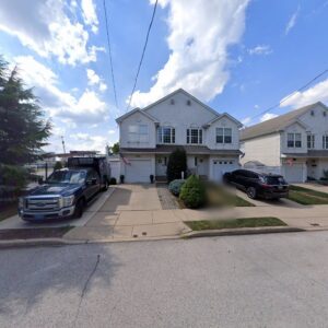 A PYK HVAC service truck parked in front of a residential home for a job in Philadelphia, PA.