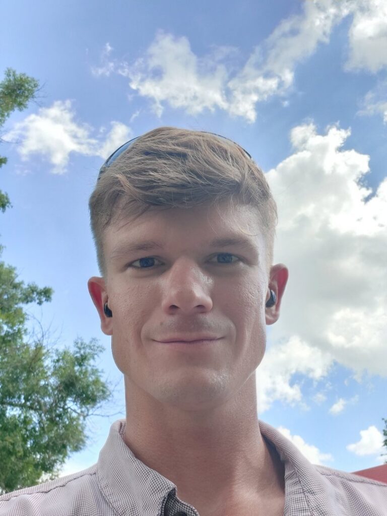 A raccoon captured in a live trap at night by Good Riddance Rodents, providing effective wildlife removal in North Austin, TX.