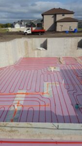 Radiant floor heating pipes being installed at a construction site by Aire Serv of Fargo, ND.