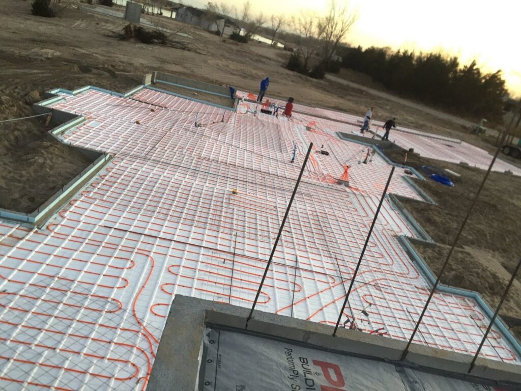 Radiant floor heating tubes being installed on a construction site by Comforttechs in Lincoln, NE.