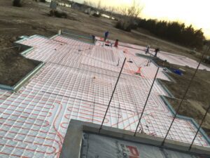 Radiant floor heating tubes being installed on a construction site by Comforttechs in Lincoln, NE.