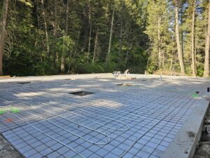 Radiant floor heating tubes laid out on a concrete slab during installation by Perfect Temp LLC in Bozeman, MT.