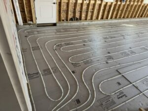 Radiant floor heating system pipes laid out on insulation during a new installation by Dischler Heating-Cooling & Fireplaces in Prairie du Sac, WI.