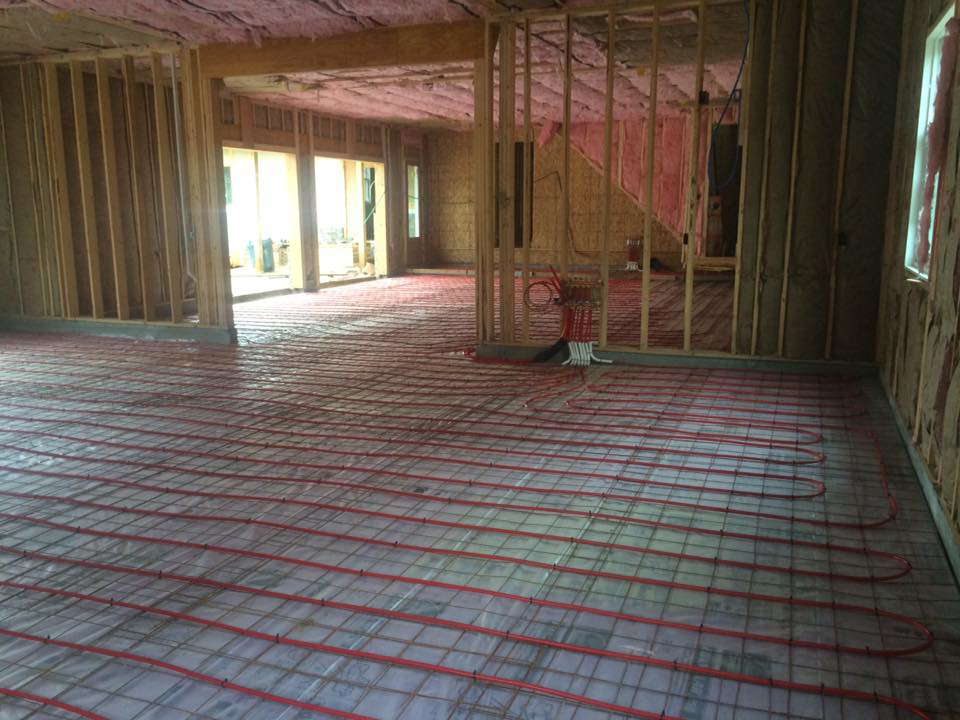 Wide view of radiant floor heating PEX tubing laid out across a subfloor by Gil-Rich Cooling & Heating LLC in Flint, MI