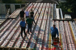 Technicians installing radiant heating tubes on a floor by ALL YEAR Heating, Air and Solar in Sacramento, CA.