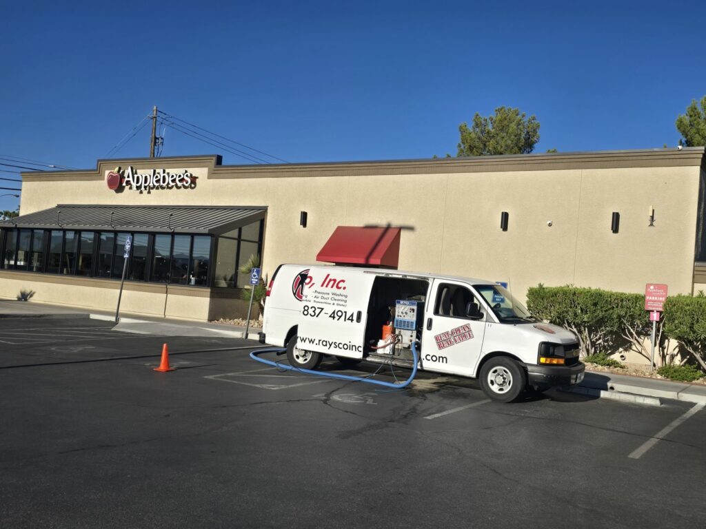 A Raysco, Inc. service van with hoses extended, indicating a commercial carpet cleaning job in Las Vegas, NV.