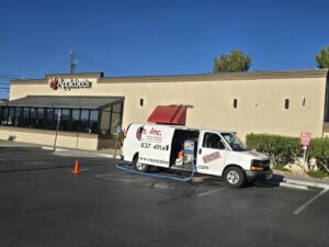 A Raysco, Inc. service van with hoses extended, indicating a commercial carpet cleaning job in Las Vegas, NV.