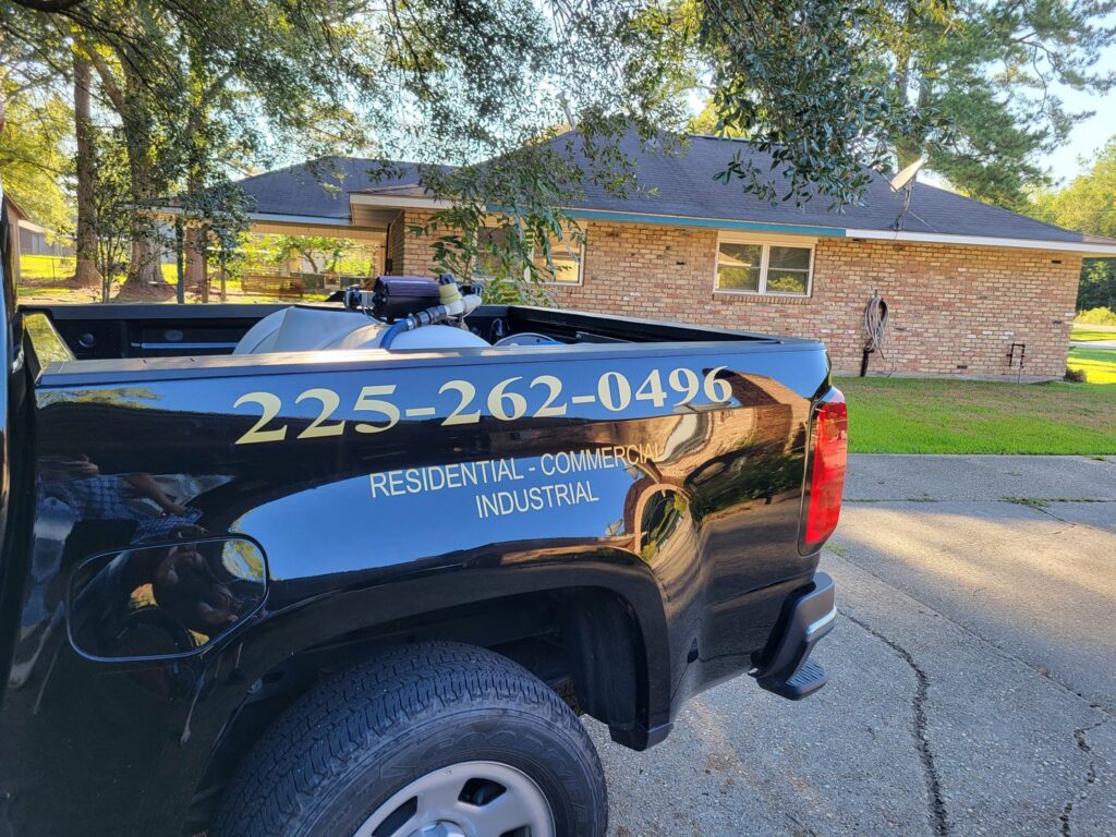 Rear view of a S&L Pest Services, LLC truck showing pest control equipment and branding, serving New Orleans, LA.