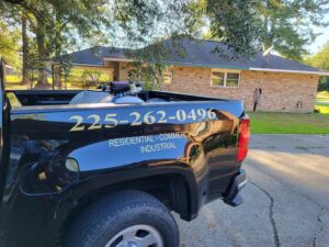Rear view of a S&L Pest Services, LLC truck showing pest control equipment and branding, serving New Orleans, LA.