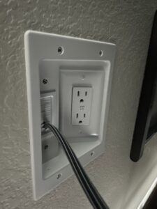 A newly installed recessed electrical outlet and cable management plate by A1 Electrical Services, LLC in Greeley, CO.