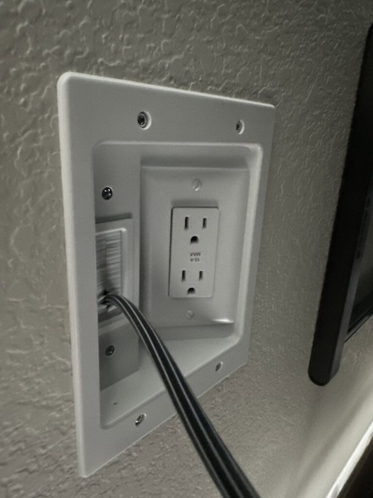 A newly installed recessed electrical outlet and cable management plate by A1 Electrical Services, LLC in Greeley, CO.