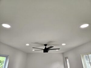 A room featuring newly installed recessed lighting and a modern ceiling fan by ALC Electric LLC in Goose Creek, SC