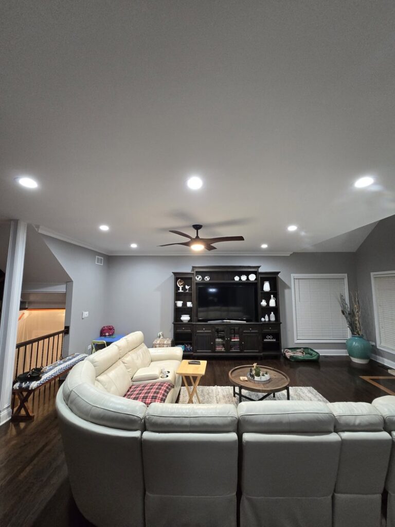 A living room with recessed lighting and a ceiling fan installed by ILIC Electric in Chicago, IL.
