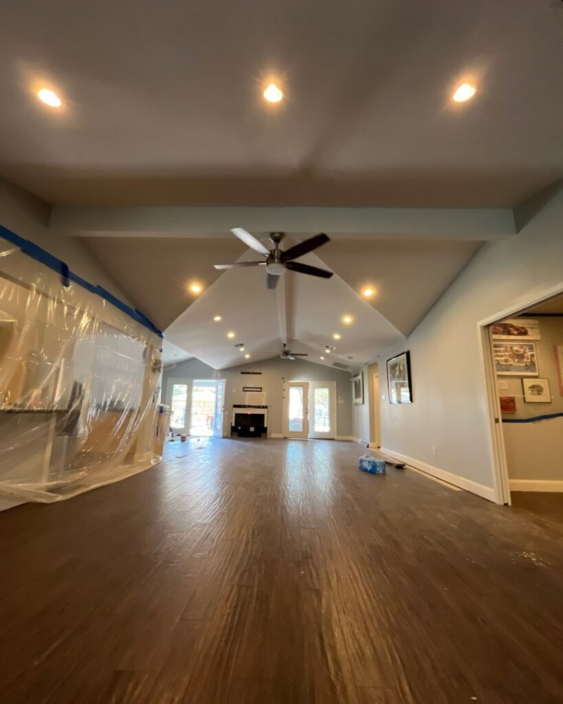 A spacious room featuring newly installed recessed lighting and ceiling fans, completed by Volt-Pro Electric, LLC in Houston, TX