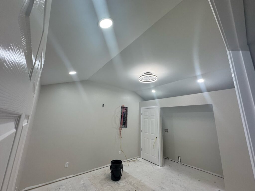 Recessed lighting and an open electrical panel with wiring in a room, showing work by Delta Current Electric in Jonesboro, AR.