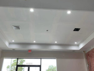 A commercial ceiling with multiple recessed lights and an exit sign, installed by Harbour Electric in Wilmington, NC.