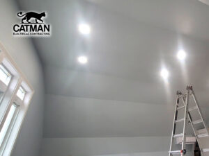 Recessed lighting installed in a ceiling with a ladder nearby, indicating work by Catman Electrical Contracting in Dallas, PA.