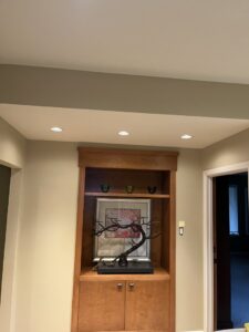 New recessed lighting installed in a ceiling above a built-in shelf by Innovate Electric in Earth City, MO.