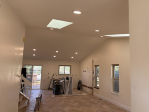 A spacious living room with newly installed recessed lighting and skylights by JayCo Lighting & Electric in Colorado Springs, CO.