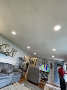 A modern living room illuminated by newly installed recessed lighting in the ceiling, completed by Rylix Electric in Cincinnati, OH.