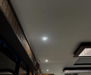 Close-up of a ceiling showing recessed lighting and exposed electrical wiring during installation by Mechatronics LLC in Memphis, TN.